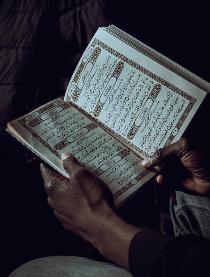 A person reading the Quran, showcasing spirituality and devotion.